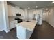 Modern kitchen features white cabinets, stainless steel appliances, and a large island with seating at 239 Paramount Dr, Smithfield, NC 27577
