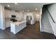 Modern kitchen features white cabinets, a stainless steel refrigerator, and an island with a sink at 239 Paramount Dr, Smithfield, NC 27577