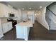 Modern kitchen features white cabinets, stainless steel appliances, and a large island with a sink at 239 Paramount Dr, Smithfield, NC 27577