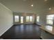 Spacious living room featuring hardwood floors and large windows allowing lots of natural light at 239 Paramount Dr, Smithfield, NC 27577