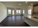 Bright open-concept living area with hardwood floors and large windows allowing lots of light at 239 Paramount Dr, Smithfield, NC 27577