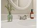 Bright bathroom vanity featuring an oval mirror, sleek faucet, decor, and modern countertop at 240 Standish Dr, Chapel Hill, NC 27517