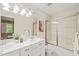 Well-lit bathroom with a double vanity, shower, and modern fixtures at 240 Standish Dr, Chapel Hill, NC 27517