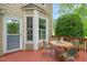 Outdoor deck features a patio table set with views of lush greenery and mature trees in the backyard at 240 Standish Dr, Chapel Hill, NC 27517