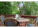 Outdoor deck features a patio table set with a small potted plant and utensils on top at 240 Standish Dr, Chapel Hill, NC 27517