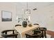 Dining area featuring a wooden table, decorative lighting, and neutral paint at 240 Standish Dr, Chapel Hill, NC 27517