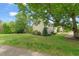 Traditional two-story home with a well-manicured lawn, mature trees, and a manicured landscape at 240 Standish Dr, Chapel Hill, NC 27517