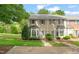 Charming townhouse featuring blue shutters, bay windows, and well-maintained landscaping at 240 Standish Dr, Chapel Hill, NC 27517