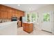 Bright kitchen with stainless appliances, center island, and door to the backyard at 240 Standish Dr, Chapel Hill, NC 27517