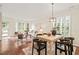 Bright living and dining room area with hardwood floors, neutral decor, and large windows at 240 Standish Dr, Chapel Hill, NC 27517