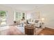 Bright living room with large windows, a comfortable sofa, and stylish decor at 240 Standish Dr, Chapel Hill, NC 27517