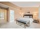 Comfortable bedroom with a sitting bench, soft carpet, and ensuite bathroom access at 240 Standish Dr, Chapel Hill, NC 27517