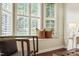 Inviting window seat with pillows and plantation shutters offering natural light and views at 240 Standish Dr, Chapel Hill, NC 27517