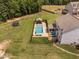 An aerial view of the backyard features a pool, lounge area, trampoline, and a well-manicured lawn at 2521 Georgianna Dr, Wake Forest, NC 27587