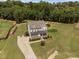 Aerial view of a landscaped yard with a winding driveway, stone accents, and lush landscaping at 2521 Georgianna Dr, Wake Forest, NC 27587
