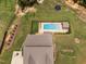 An aerial view of the backyard with a swimming pool, lounge seating, and lush landscaping at 2521 Georgianna Dr, Wake Forest, NC 27587