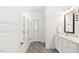 Bathroom with gray wood-look tile floors and shower with frameless glass door at 2521 Georgianna Dr, Wake Forest, NC 27587