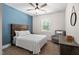 Cozy bedroom featuring a modern ceiling fan, plush carpet, and a decorative accent wall at 2521 Georgianna Dr, Wake Forest, NC 27587