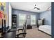 Blue toned bedroom with work desk, bed, fan and open windows at 2521 Georgianna Dr, Wake Forest, NC 27587