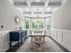 Formal dining room with coffered ceilings, wainscoting, a bay window and decorative light fixture at 2521 Georgianna Dr, Wake Forest, NC 27587