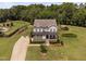 An exterior elevation of a home with a stone foundation, well maintained front lawn and mature landscaping at 2521 Georgianna Dr, Wake Forest, NC 27587