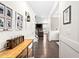 Inviting hallway with dark wood floors, white trim and board and batten detail throughout the home at 2521 Georgianna Dr, Wake Forest, NC 27587