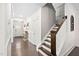 Hallway featuring wood floors, white walls, board and batten, and a staircase with stained banister at 2521 Georgianna Dr, Wake Forest, NC 27587