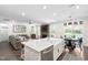 Open floor plan with white cabinets and island overlooking the living room with modern décor and a fireplace at 2521 Georgianna Dr, Wake Forest, NC 27587