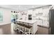 Bright kitchen featuring white cabinets, quartz countertops, a center island with seating, and stainless steel appliances at 2521 Georgianna Dr, Wake Forest, NC 27587