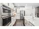 Close up of a well-appointed kitchen featuring stainless steel appliances, white cabinets and quartz countertops at 2521 Georgianna Dr, Wake Forest, NC 27587