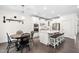 Bright, modern kitchen with white cabinets, stainless steel appliances, a large island with bar stools and adjacent dining area at 2521 Georgianna Dr, Wake Forest, NC 27587