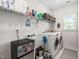 Well-lit laundry room with washer, dryer, sink, shelving and beverage cooler at 2521 Georgianna Dr, Wake Forest, NC 27587
