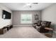Upstairs living room with large window, new carpet, ceiling fan, media center, and leather seating at 2521 Georgianna Dr, Wake Forest, NC 27587