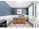 Stylish home office featuring paneled walls, a large wooden desk, and modern decor at 2521 Georgianna Dr, Wake Forest, NC 27587