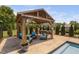 Outdoor pergola with seating area and bar, perfect for entertaining guests and relaxing by the pool at 2521 Georgianna Dr, Wake Forest, NC 27587