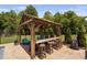 Charming outdoor pergola featuring a bar, seating, and a view of the backyard and pool area at 2521 Georgianna Dr, Wake Forest, NC 27587