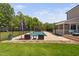 Inviting backyard oasis with a sparkling pool, lounge area, and a charming wooden pergola for outdoor entertaining at 2521 Georgianna Dr, Wake Forest, NC 27587