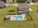 Aerial view of a beautiful backyard pool and lounge area with well-maintained landscaping and privacy fence at 2521 Georgianna Dr, Wake Forest, NC 27587