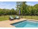 Beautiful pool with seating area and well-maintained backyard, perfect for outdoor relaxation and enjoyment at 2521 Georgianna Dr, Wake Forest, NC 27587