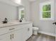 Bathroom featuring double sink vanity with white cabinets, gray walls, and modern fixtures at 2921 Wall Store Rd, Garner, NC 27529