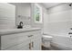 Modern bathroom with white vanity, dark hardware, shower and tub at 2921 Wall Store Rd, Garner, NC 27529