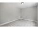 Neutral bedroom with modern ceiling light, carpet, and light gray walls at 2921 Wall Store Rd, Garner, NC 27529