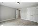 Modern bedroom with neutral tones, carpet, and double doors at 2921 Wall Store Rd, Garner, NC 27529