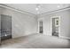 Large bedroom with neutral carpet, gray walls, recessed lighting and view to closet and bathroom at 2921 Wall Store Rd, Garner, NC 27529