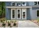 Close-up of front door featuring modern fixtures and manicured landscape at 2921 Wall Store Rd, Garner, NC 27529