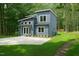Stylish two-story home with board and batten siding, a concrete driveway, and well-maintained lawn at 2921 Wall Store Rd, Garner, NC 27529