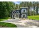 Two-story home featuring board and batten siding, a concrete driveway, and professionally landscaped yard at 2921 Wall Store Rd, Garner, NC 27529