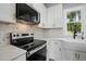 Close up on kitchen featuring white cabinets, stainless steel appliances, and white countertops at 2921 Wall Store Rd, Garner, NC 27529