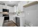Bright kitchen featuring white cabinets, stainless steel appliances, white countertops, and a modern faucet at 2921 Wall Store Rd, Garner, NC 27529