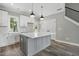 Stylish kitchen featuring an island, white cabinets and stainless steel appliances at 2921 Wall Store Rd, Garner, NC 27529